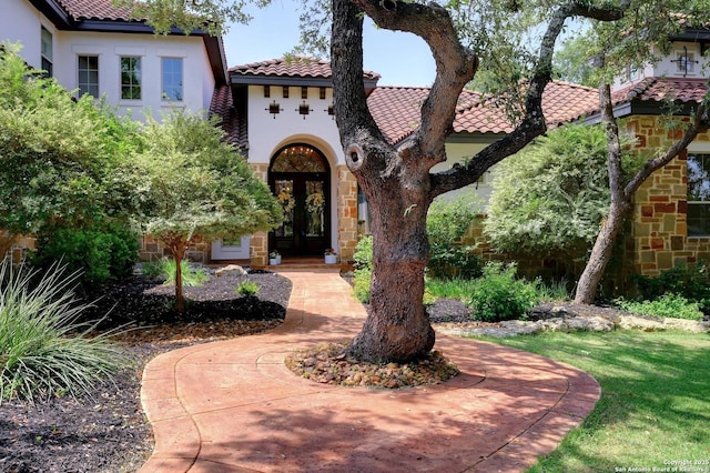 133 Fair Spgs, Boerne, TX 78006 - mediterranean / spanish-style house featuring a tiled roof, french doors, stucco siding, and stone siding
