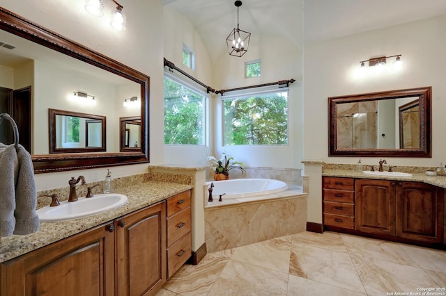 133 Fair Spgs, Boerne, TX 78006 - bathroom with two vanities, a garden tub, a chandelier, marble finish floors, and lofted ceiling