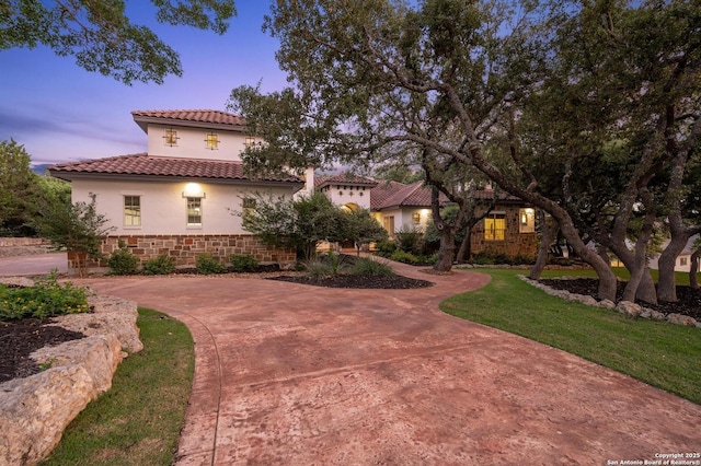 133 Fair Spgs, Boerne, TX 78006 - mediterranean / spanish-style home with a tile roof, stucco siding, stone siding, and a lawn