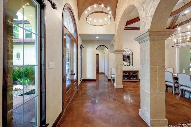 133 Fair Spgs, Boerne, TX 78006 - foyer featuring a chandelier, concrete flooring, ornate columns, arched walkways, and a high ceiling