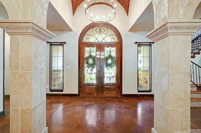 133 Fair Spgs, Boerne, TX 78006 - entrance foyer with stairway, finished concrete floors, french doors, a chandelier, and baseboards