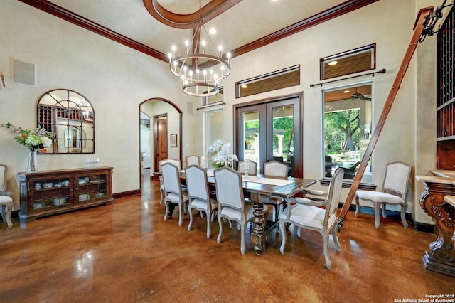 133 Fair Spgs, Boerne, TX 78006 - dining area with finished concrete flooring, crown molding, arched walkways, baseboards, and french doors