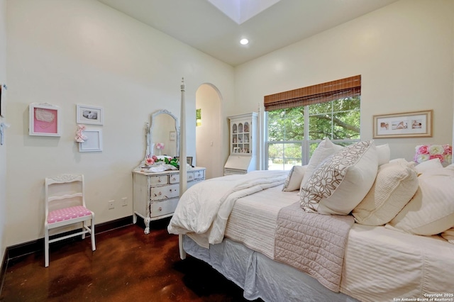 133 Fair Spgs, Boerne, TX 78006 - bedroom with finished concrete floors, arched walkways, recessed lighting, and baseboards