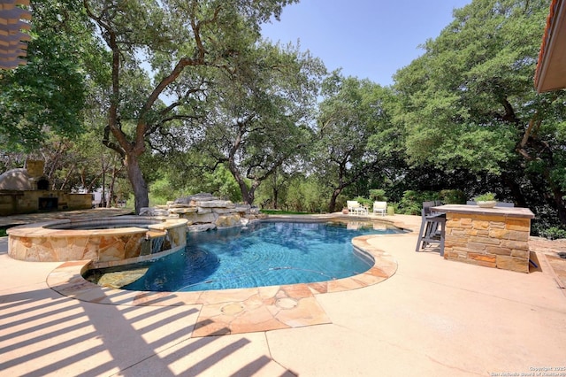 133 Fair Spgs, Boerne, TX 78006 - view of pool with a patio, a pool with connected hot tub, and view of scattered trees