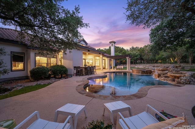 133 Fair Spgs, Boerne, TX 78006 - pool at dusk with an in-ground hot tub, a patio area, and an outdoor pool