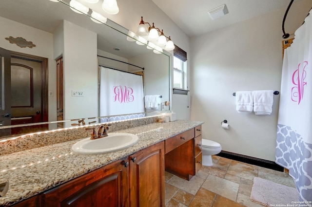 133 Fair Spgs, Boerne, TX 78006 - full bathroom with vanity, stone tile floors, baseboards, toilet, and a shower with shower curtain