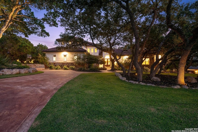 133 Fair Spgs, Boerne, TX 78006 - view of front facade with driveway, stucco siding, a front lawn, and a tile roof