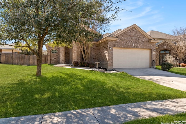 view of front facade with brick siding, fence, concrete driveway, a front yard, and an attached garage