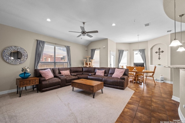 living area with visible vents, a healthy amount of sunlight, and baseboards