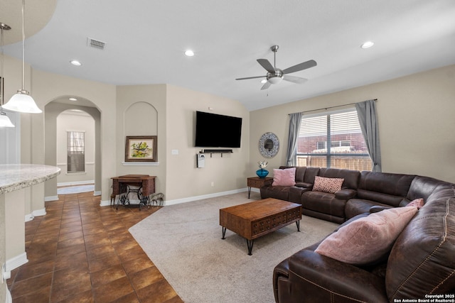 living room with visible vents, baseboards, recessed lighting, arched walkways, and a ceiling fan