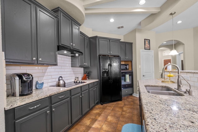 kitchen with visible vents, arched walkways, a sink, black appliances, and under cabinet range hood