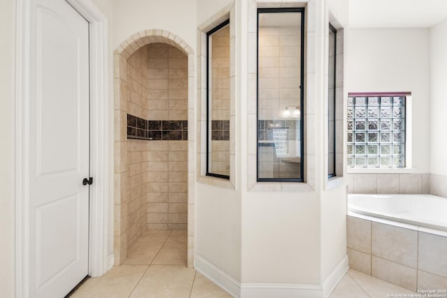 bathroom with tile patterned floors, a garden tub, and walk in shower