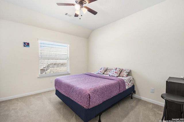 carpeted bedroom with visible vents, lofted ceiling, baseboards, and ceiling fan