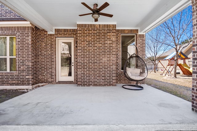 view of patio with a playground and a ceiling fan