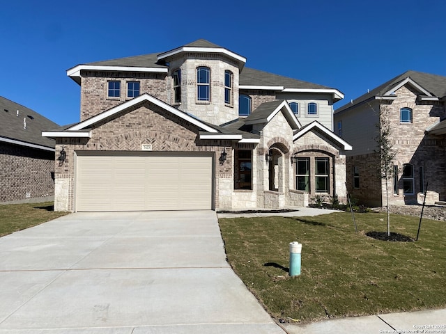 french country inspired facade featuring driveway, a front lawn, stone siding, a garage, and brick siding