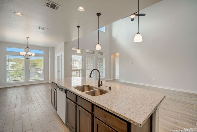 kitchen with a sink, visible vents, dishwasher, and wood tiled floor