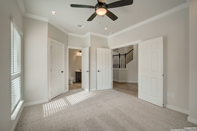 unfurnished bedroom featuring visible vents, baseboards, light colored carpet, and ornamental molding