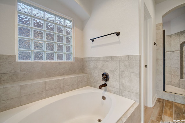 full bathroom with a garden tub, wood finished floors, and a stall shower