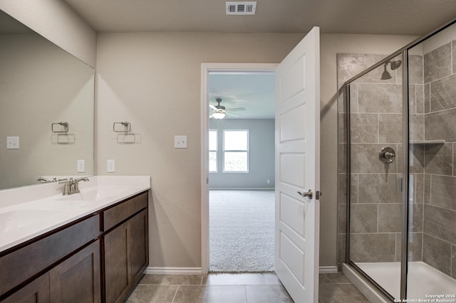 bathroom featuring tile patterned floors, visible vents, a stall shower, and a sink