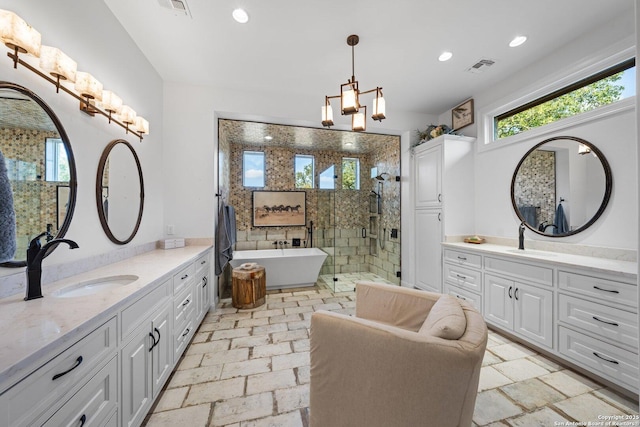 bathroom featuring a stall shower, two vanities, visible vents, and a sink