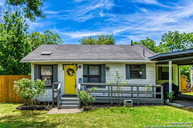 ranch-style house with covered porch, a front lawn, and fence