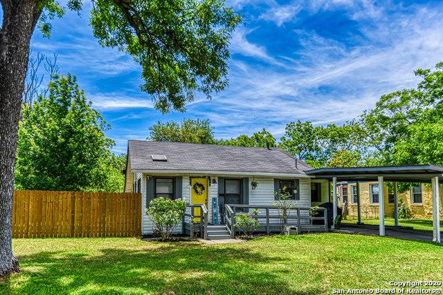 single story home featuring a front yard, fence, and a carport