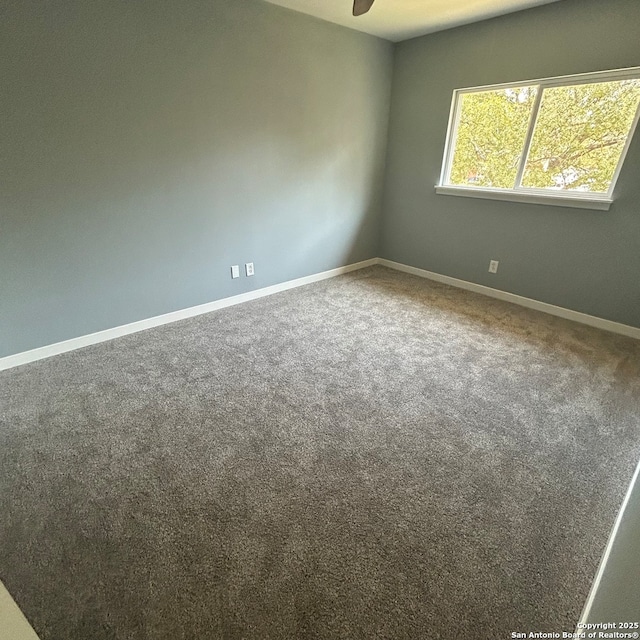 unfurnished room with baseboards, carpet, and ceiling fan