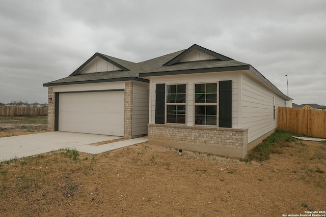 single story home with an attached garage, fence, brick siding, and driveway