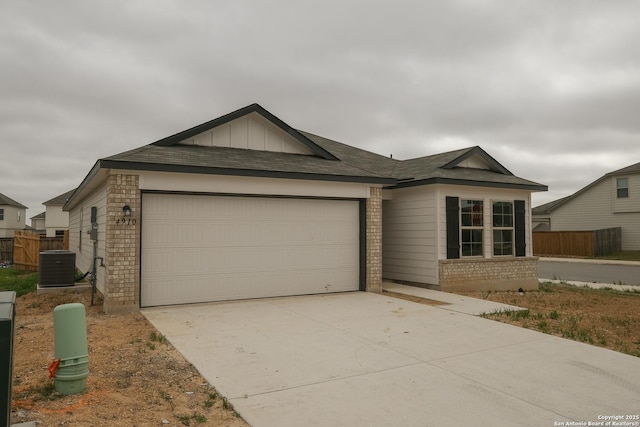 ranch-style house featuring brick siding, board and batten siding, concrete driveway, cooling unit, and a garage