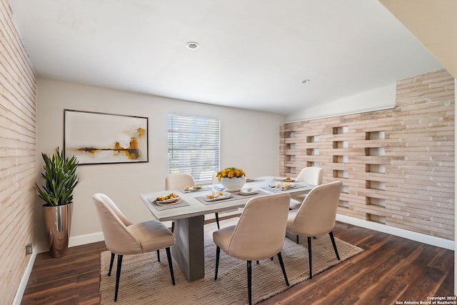 dining area featuring baseboards, lofted ceiling, and dark wood-style flooring