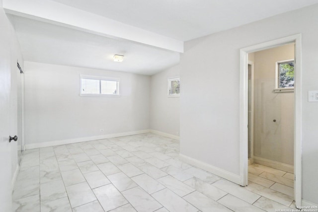 spare room with baseboards and marble finish floor