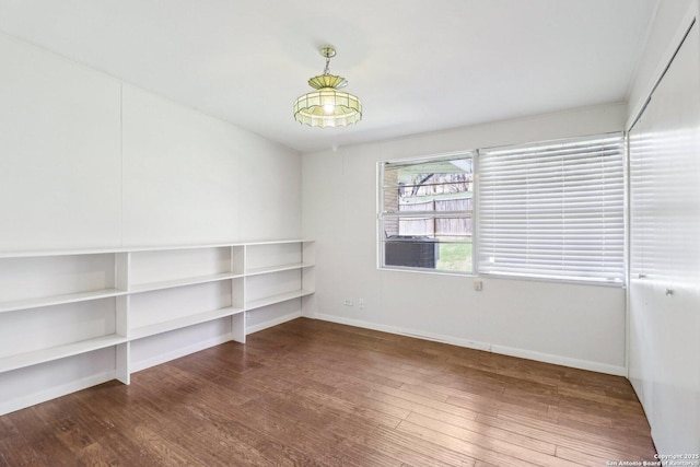 spare room with wood finished floors and baseboards