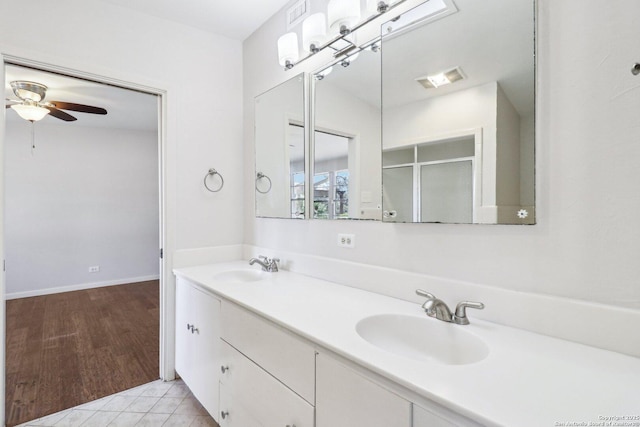 full bath featuring tile patterned floors, double vanity, a ceiling fan, and a sink