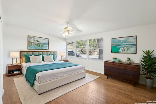 bedroom with a ceiling fan and wood finished floors