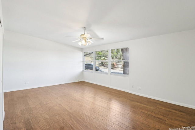 empty room with wood finished floors, baseboards, and ceiling fan