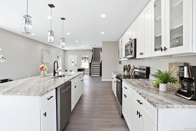 650 Canyon Cir, Canyon Lake, TX 78133 - kitchen with appliances with stainless steel finishes, a sink, recessed lighting, wood finished floors, and decorative light fixtures