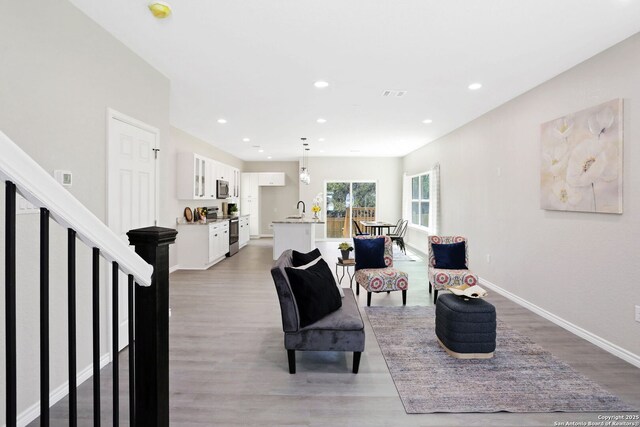 650 Canyon Cir, Canyon Lake, TX 78133 - living room featuring light wood-type flooring, baseboards, and recessed lighting