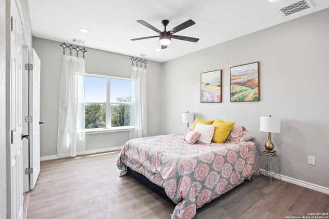 650 Canyon Cir, Canyon Lake, TX 78133 - bedroom with wood finished floors, baseboards, ceiling fan, and recessed lighting