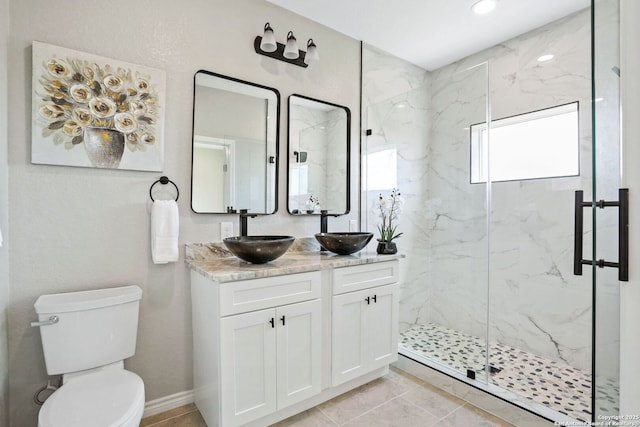 650 Canyon Cir, Canyon Lake, TX 78133 - full bath featuring a marble finish shower, toilet, double vanity, and baseboards