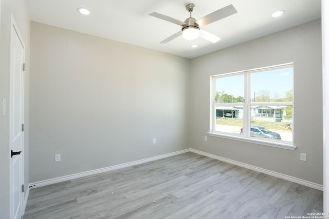 spare room featuring light wood-style floors, baseboards, a ceiling fan, and recessed lighting
