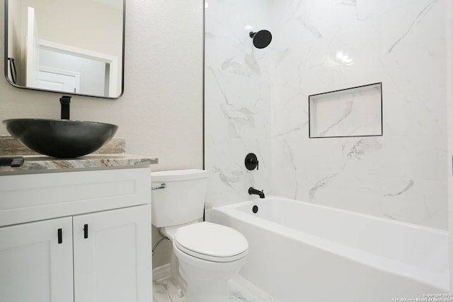 bathroom featuring toilet, marble finish floor, vanity, and shower / bathtub combination