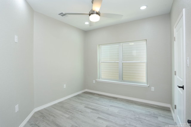 spare room featuring light wood-type flooring, a ceiling fan, visible vents, recessed lighting, and baseboards