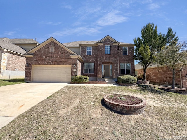 traditional-style house featuring concrete driveway, an attached garage, and brick siding