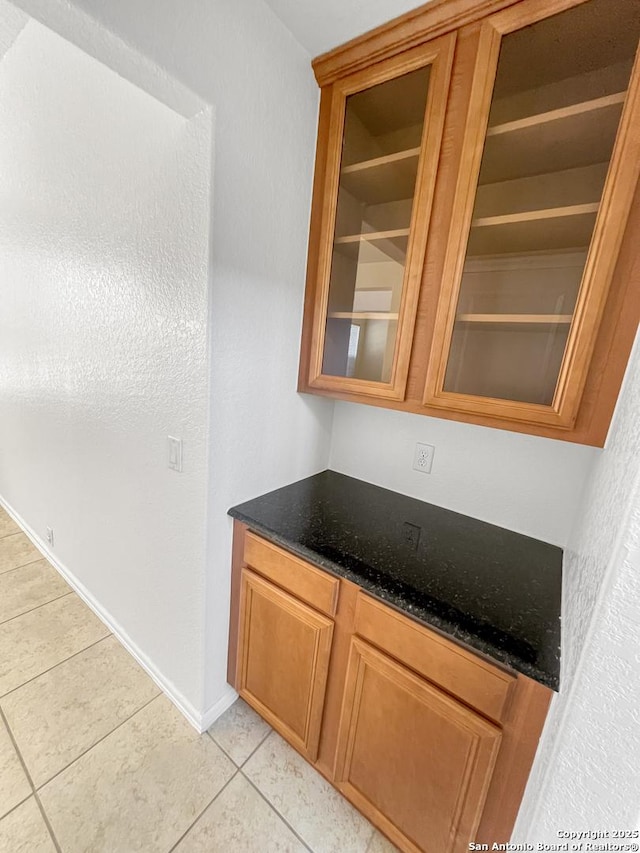 bar with light tile patterned flooring and baseboards