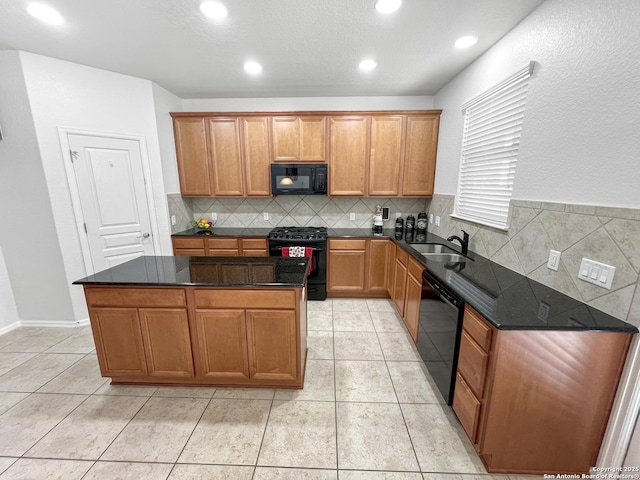 kitchen featuring a sink, black appliances, a center island, and light tile patterned floors