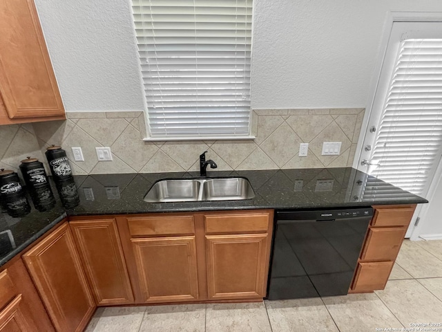 kitchen featuring dark stone counters, a sink, decorative backsplash, dishwasher, and brown cabinets