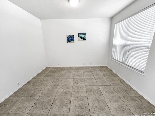 tiled spare room with baseboards