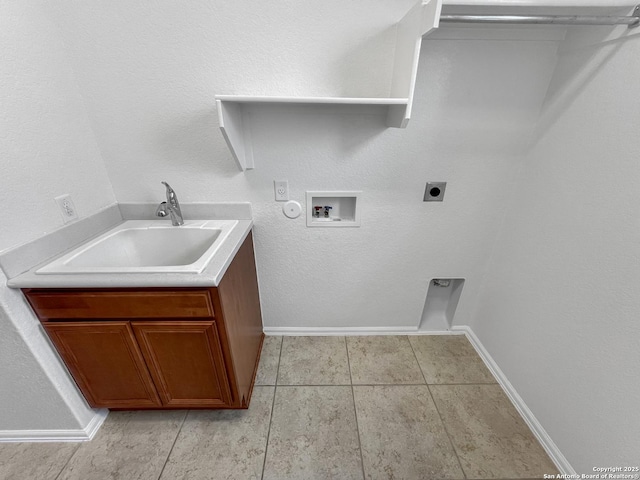 washroom with baseboards, washer hookup, light tile patterned floors, hookup for an electric dryer, and a sink