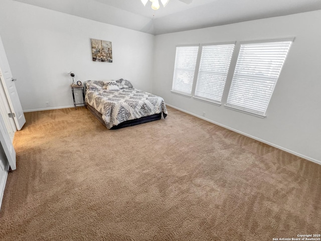 bedroom featuring vaulted ceiling, baseboards, and carpet floors