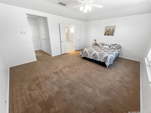 carpeted bedroom featuring visible vents, baseboards, ceiling fan, and ensuite bathroom